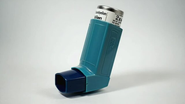 Ventolin inhaler on a light background.