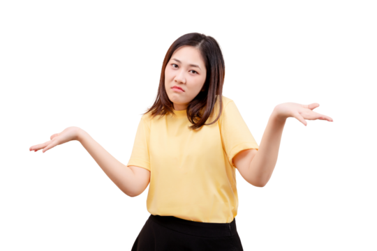 Asian young beautiful woman in a yellow shirt shrugs with both hands raised and a confused expression.
