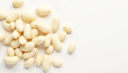 Scattered white beans on pure white background, food styling, healthy