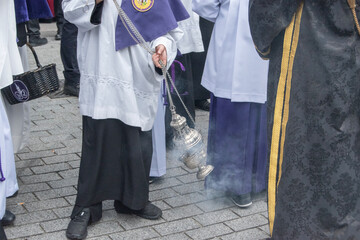 an altar boy in an Easter procession in Madrid carrying a censer