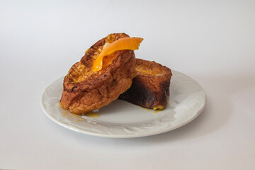 Plate  with three Torrijas Spanish french toast  isolated on white background