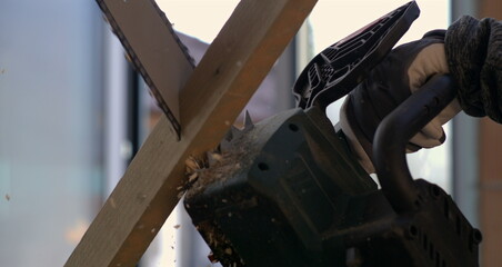 Close-up of chainsaw blade cutting through wood in slow-motion at 800 fps, wood splinters flying, focus on intense cutting action and chainsaw precision