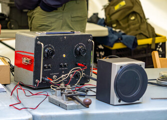Close-up of vintage radio equipment with a transmitter and Morse code key, set up on a table....