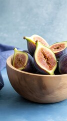 Fresh Ripe Purple Figs Half Cut in Wooden Bowl on Blue Background Closeup
