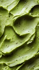 Green Creamy Texture with Dark Specks, CloseUp of Dense Viscous Material