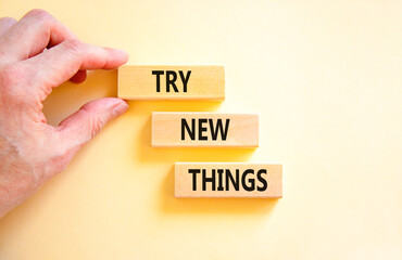 Try new things symbol. Concept words Try new things on beautiful wooden block. Businessman's hand. Beautiful white background. Business motivational lifestyle try new things concept. Copy space.
