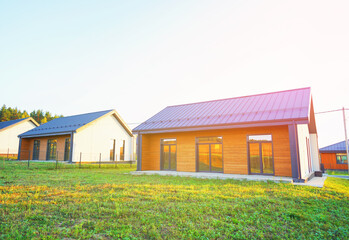 New modern home on sunset Suburban housing. Suburb Residential house in suburban neighborhood....