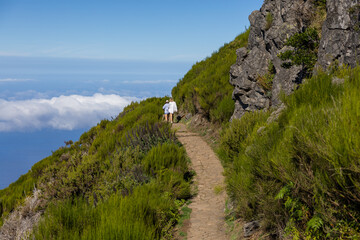 Hiking trail with tourists in the mountains of Pico Ruivo. Madeira island, Portugal.