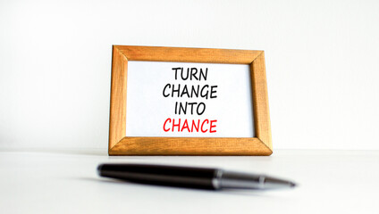 Turn change into chance symbol. Concept words phrase Turn change into chance on beautiful wooden...