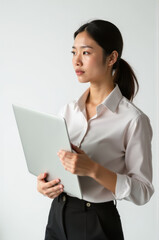 Obraz premium A woman sitting and holding a laptop, possibly working or learning