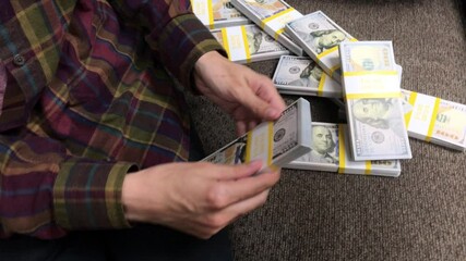 Young Woman Counts Stacks of Cash $100 Bills