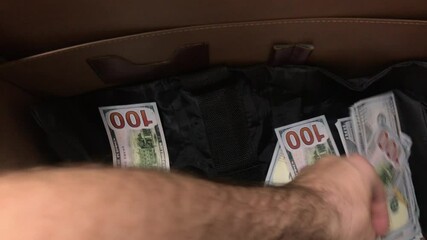Young Man Handles Cash In Suitcase