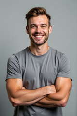 A person with a friendly expression and crossed arms, possibly conveying confidence or relaxation