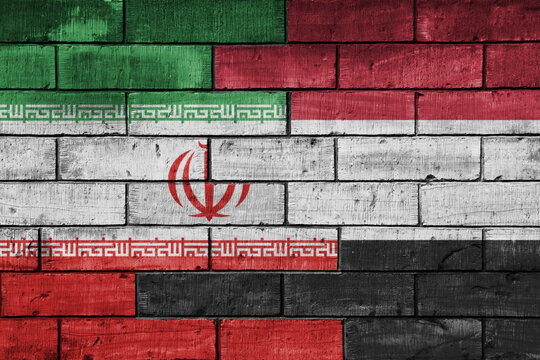 colourful painted big national flag of yemen and flag of iran on a massive old brick wall background. concept
