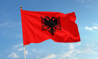 Albanian national flag waving in wind with black double-headed eagle on bright red background