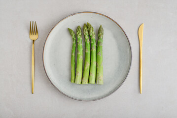 Green asparagus stems on a plate