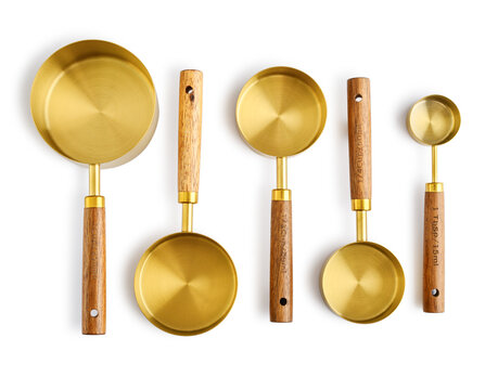 Golden measuring spoons with wooden handles