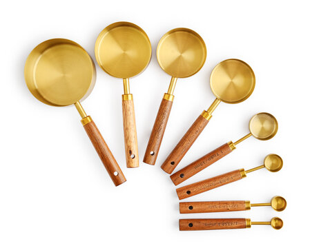 Golden measuring spoons with wooden handles