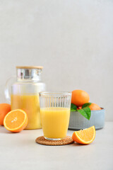 Orange fresh squeezed juice in glass and glasses jug