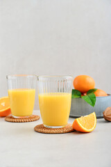 Orange fresh squeezed juice in glass and glasses jug