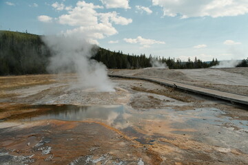 Beautiful steaming scenery at Yellowstone National Park Wyoming upper geyser basin with boardwalk