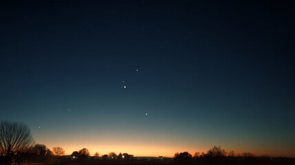 Naklejka premium A serene twilight sky with a celestial alignment of planets above a silhouetted landscape offers a tranquil view of the universe’s grandeur.