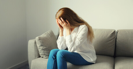 Upset sad crying woman while experiencing mental suffering, depression, fatigue, emotional stress