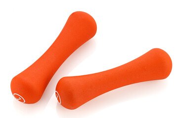 Two orange rubberized dumbbells isolated on white background. Sports equipment. Full depth of field.