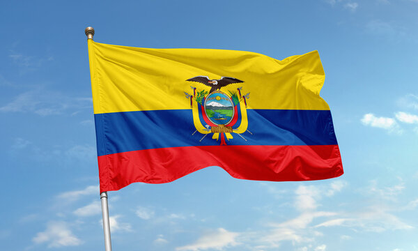 Ecuador national flag with coat of arms waving under blue sky