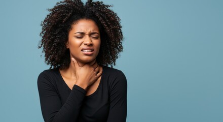 Portrait of an African woman touching her neck with a pained expression, indicating possible sore throat, neck tension, or swollen lymph nodes. Neutral gray background. Concept of illness, discomfort,