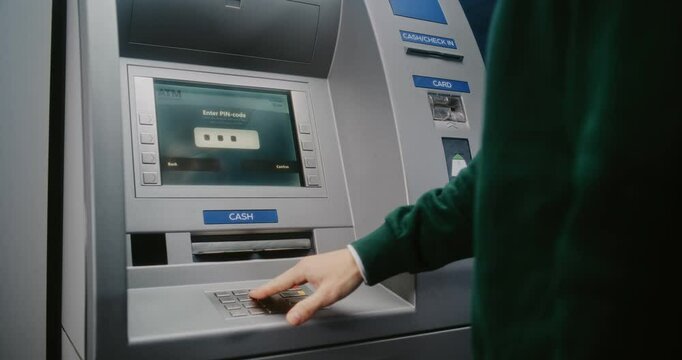 Unrecognizable Person Entering PIN Code on ATM Keypad to Withdraw Money. Error Message on Cash Machine Display About Transaction Cancellation Due to No Cash Available. Banking Equipment. Close Up.