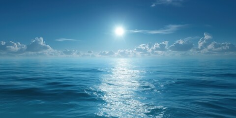 The sun is shining on the ocean, creating a beautiful and serene scene. The water is calm and the sky is clear, making for a perfect day to be out on the water