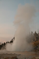 Old Faithful Geyser erupting during the day time in yellowstone national park
