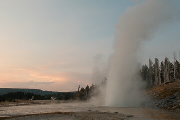 Old Faithful Geyser erupting during the day time in yellowstone national park