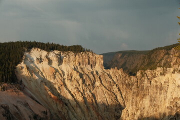 Grand Canyon of the Yellowstone National Park, cliffs and water golden hour