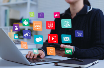 Social Media and Digital Marketing Strategy Concept. Woman using laptop and smartphone while...