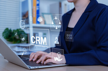 CRM Customer Relationship Management Technology Concept. Businesswoman using laptop with CRM icons,...