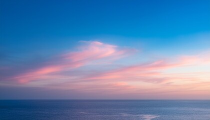 Fototapeta premium serene morning sky with pastel tones of pink and blue as the sun rises