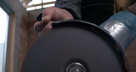 Angle grinder cutting through metal pipe, sparks flying in super slow motion at 800 fps, showcasing...