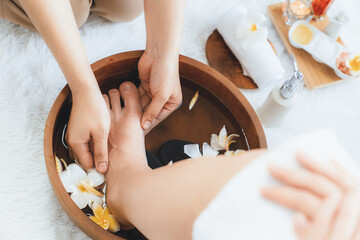 Woman indulges in blissful foot massage at luxurious spa salon while masseur give reflexology...
