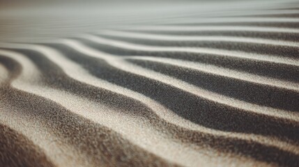 Soft sand forms gentle ripples in sunlight, creating a mesmerizing pattern that evokes the essence of a serene, natural landscape.
