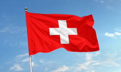 Switzerland national flag with white cross on red flying in the wind