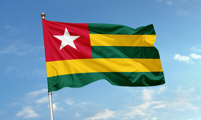 Togo national flag waving in blue sky