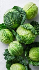 Fototapeta premium Fresh Green Cabbages Arranged on a Light Background Ready for Harvest or Cooking