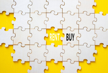 Obraz premium Rent or Buy symbol. Concept word Rent or Buy on wooden puzzle. Beautiful yellow background. Business and Rent or Buy concept. Copy space