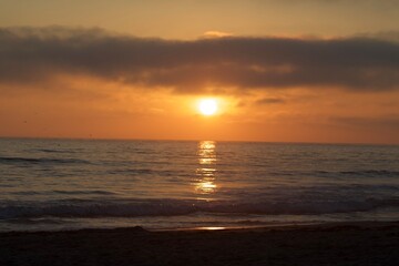 Beautiful big sun during sunset in pacific beach san diego california, orange skies