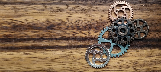 Intricate mechanical gears arrangement on wooden surface close-up industrial setting creative perspective