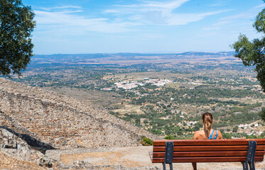 Woman contemplating the horizon from the bench