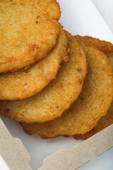 Fast food: potato pancakes in packaging on a white background. Serving for a bar, menu.