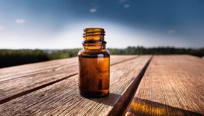 amber glass bottle of essential oil on a wooden surface